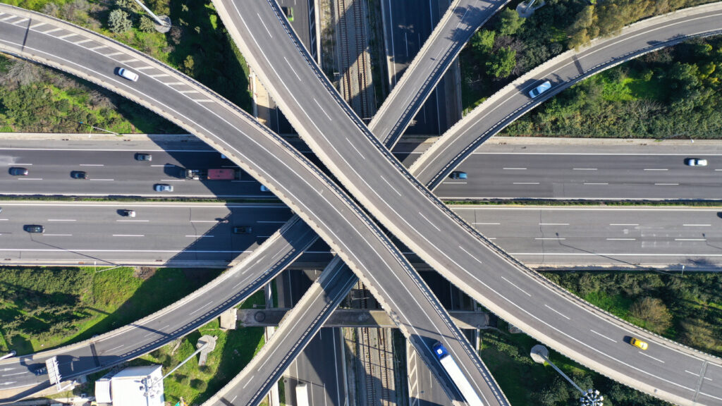 An aerial shot of a multi-lane intersection of roads and bridges