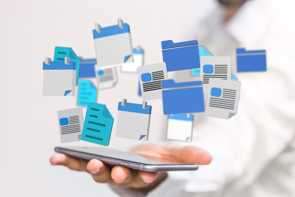 A cloud of document, calendar and file icons hovers over a smartphone held by a hand