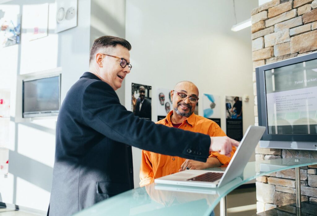 people pointing at a screen in the office